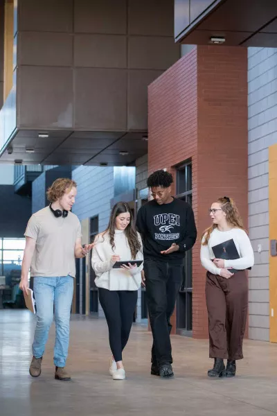 four students walking in the Faculty of Sustainable Design Engineering building