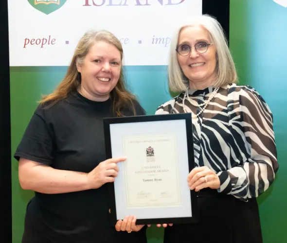 Tammy Ryan, Service Worker with UPEI Facilities Management, accepts the University Ambassador Award from Dr. Wendy Rodgers, UPEI President and Vice-Chancellor. Tammy Ryan, Service Worker with UPEI Facilities Management, accepts the University Ambassador Award from Dr. Wendy Rodgers, UPEI President and Vice-Chancellor.
