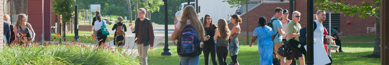 students in the quad in front of steel building