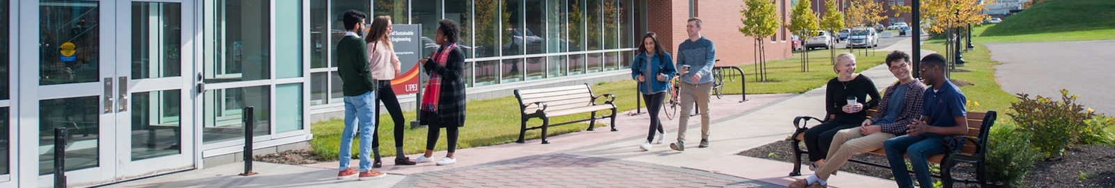 student in front of the faculty of sustainable design engineering building