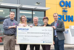 Five people hold a large cheque from Ultramar