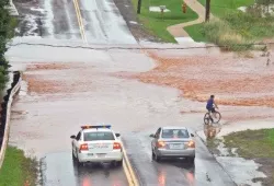 A river floods over a highway 