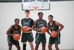 photo of four UPEI Men's Basketball players each holding a basketball