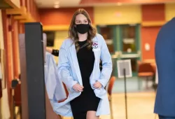 Leah Hocquard, Class of 2025 Doctor of Veterinary Medicine student, receives her blue coat symbolizing the start of her veterinary medicine journey.