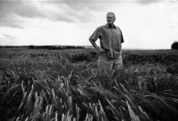 Dr. Brent MacLaine standing in field. Photo by John Sylvester