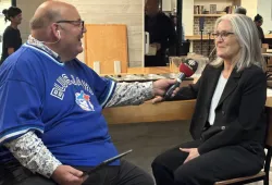 CBC PEI's Mitch Cormier interviews President Wendy Rodgers during the live radio broadcast of Island Morning that took place on campus on October 9 Man holding a microphone while interviewing a woman
