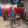 a welder standing behind a work table