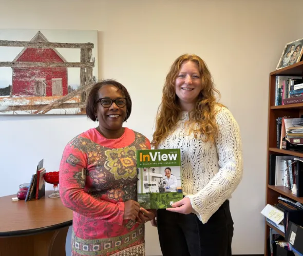 Dr. Marva Sweeney-Nixon, Associate Vice-President Research and Dean of Graduate Studies, and Julie VanLeeuwen, Research Navigator, display a copy of "InView," UPEI's new research magazine. Two women holding magazine