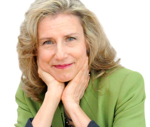 A smiling white woman with shoulder-length white hair