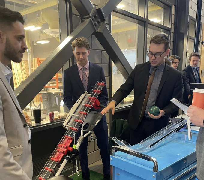 Year 2 student design team members Sami Yacoub, Spencer Blacquiere and Adam MacKenzie demonstrate their Bocce Ball Assist Ramp for Wheelchair Athletes. Their design received the OCII Award for the project that best demonstrates the potential for commercialization. 