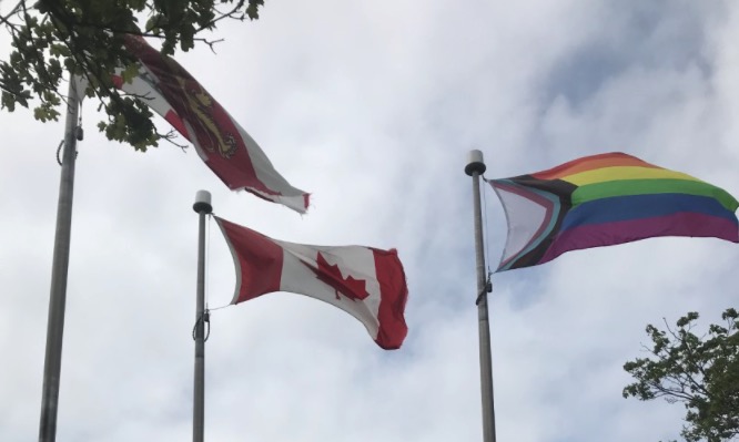 Photo of Progress Pride flag flying along side PEI and Canada flags