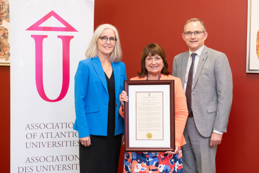 Dr. Wendy Rodgers (left), president and vice-chancellor of UPEI, and Dr. Robert Summerby-Murray, chair of the Association of Atlantic Universities (right), congratulate Dr. Jo-Ann MacDonald, professor in the Faculty of Nursing at UPEI, on winning the AAU’s 2024 Anne Marie MacKinnon Educational Leadership Award.