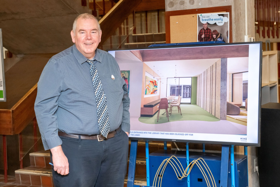 University Librarian Donald Moses with a conceptual drawing of a renovated library space