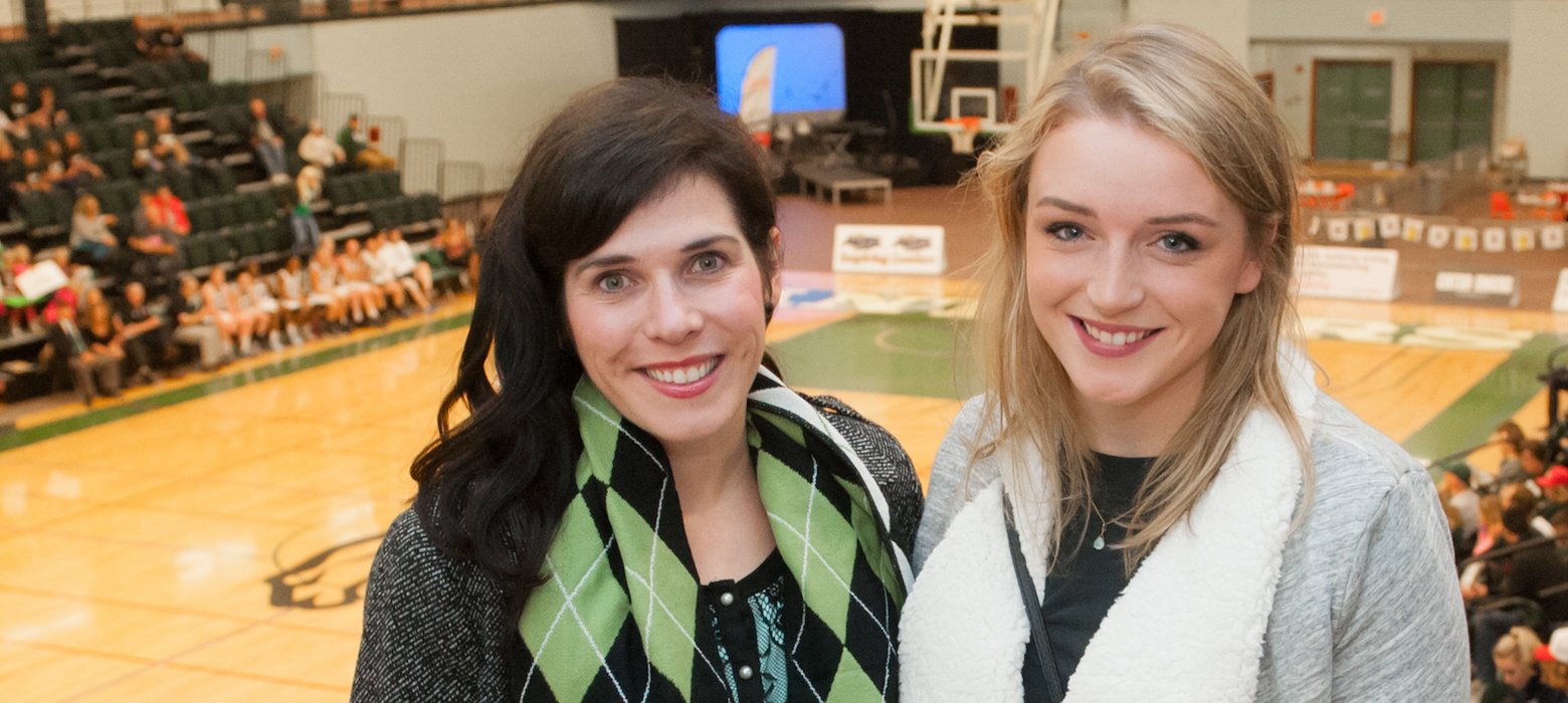 two spectators at a college basketball game