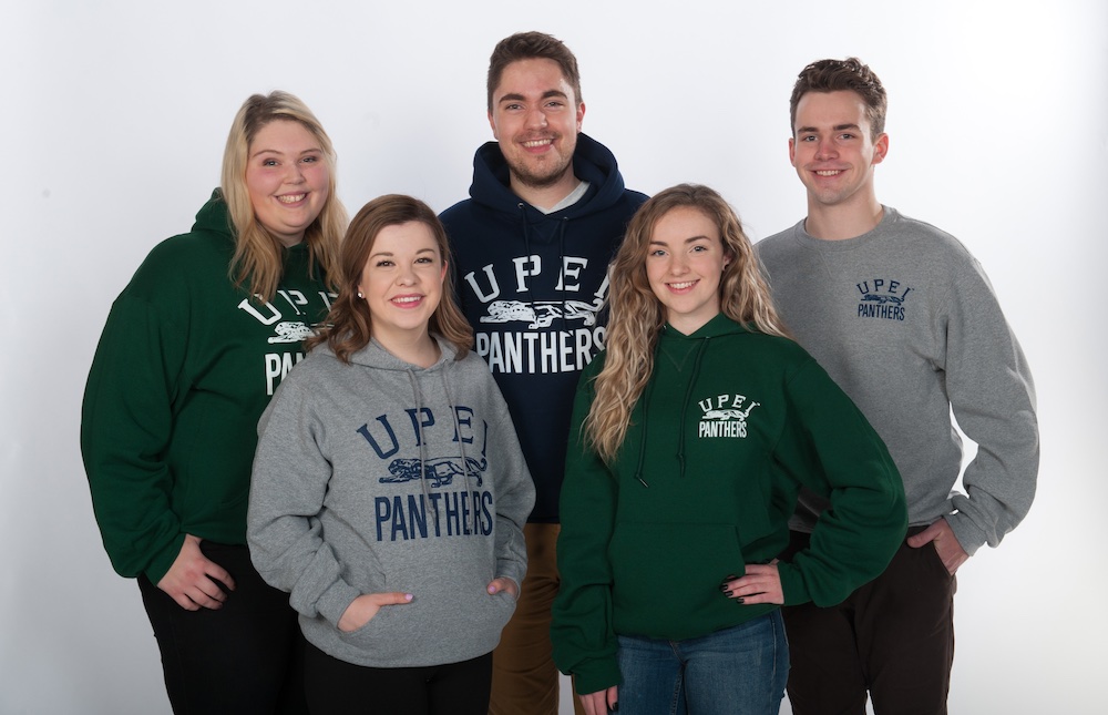 five UPEI students wearing UPEI-branded sweatshirts