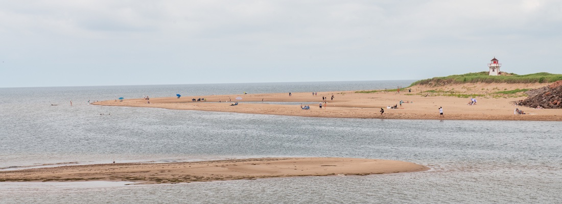 Covehead Beach with people and a lighthouse