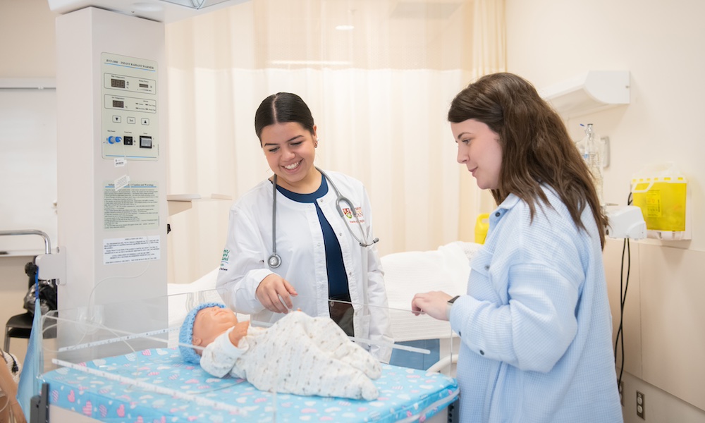 UPEI nursing student Mariana and a nursing instructor in the paediatric lab