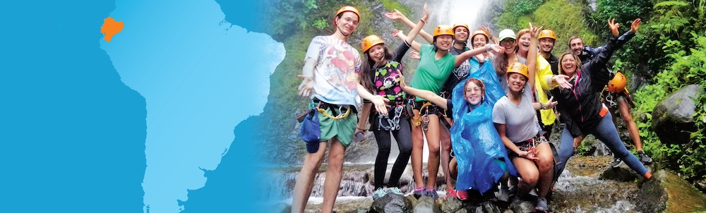 a group of students wearing helmets at a waterfall