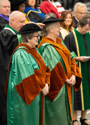 Photo of a man placing a hat on a woman at a convocation ceremony