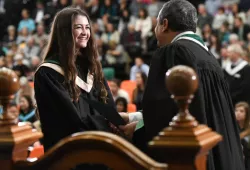 A student accepts her degree