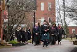 photo of convocation academic procession led by a bagpiper