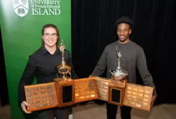 photo of woman and man holding trophies