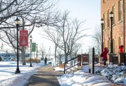 photo of the walkway with holiday banners in the quad during winter