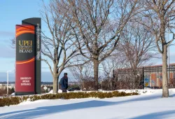 sign in front of university in winter