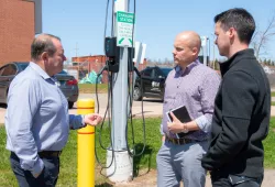 Fred Horrelt, associate vice-president facilities management and construction at UPEI, discusses the new EV chargers with Ross Dwyer, manager of research partnerships at the Canadian Centre for Climate Change and Adaptation, and Nathan MacLeod, manager of capital projects and planning at UPEI.