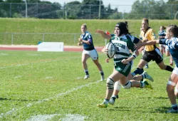 Alysha Corrigan carries the ball during a rugby match while she was a student-athlete at UPEI