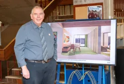 University Librarian Donald Moses with a conceptual drawing of a renovated library space