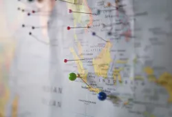 coloured pins stuck in a map