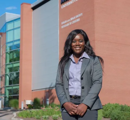 student in front of duffy research centre