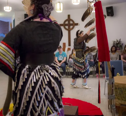 two indigenous women dancing in upei's chaplaincy centre