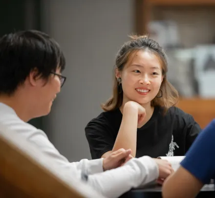 students speaking in the Library