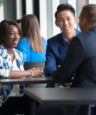 Students sit at a table talking