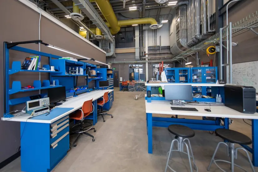 student workstations and blue desks in a shop area in the Faculty of Sustainable Design Engineering building