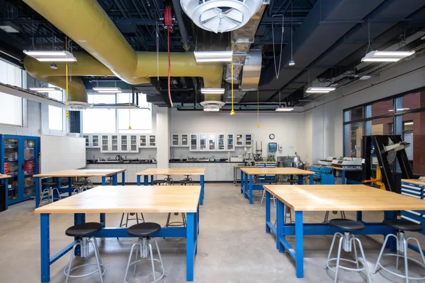 student workstations and blue desks in a shop area in the Faculty of Sustainable Design Engineering building