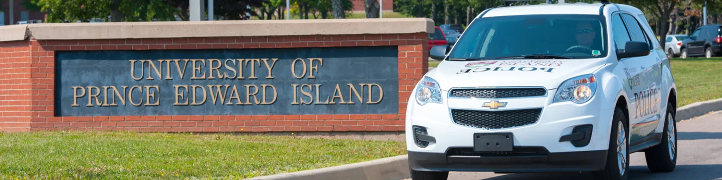 UPEI Security vehicle in front of university main entrance sign