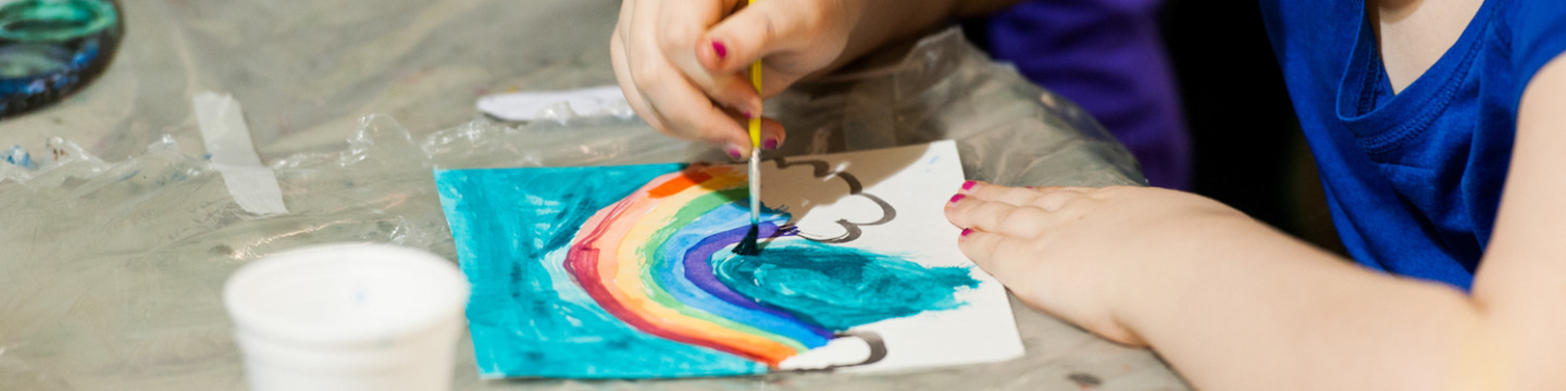 child painting a rainbow