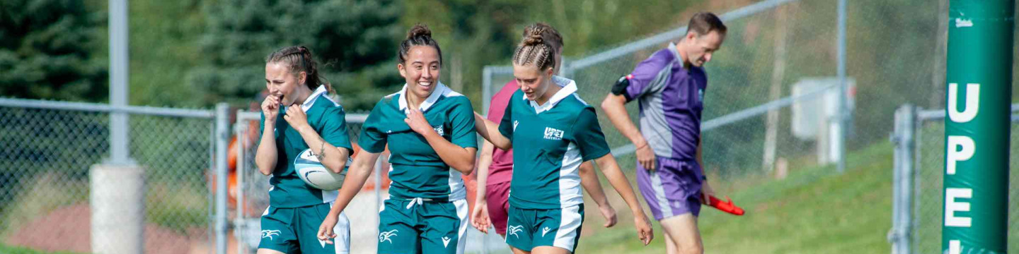 Three UPEI rugby athletes on the field 