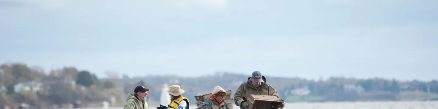 four shellfish harvesters on an oyster boat