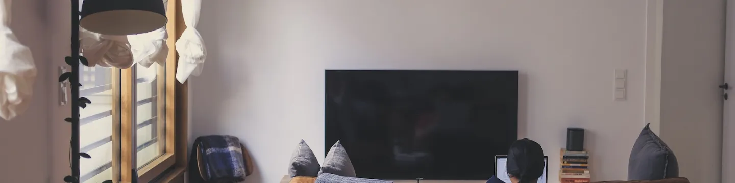 a student at a laptop in an apartment