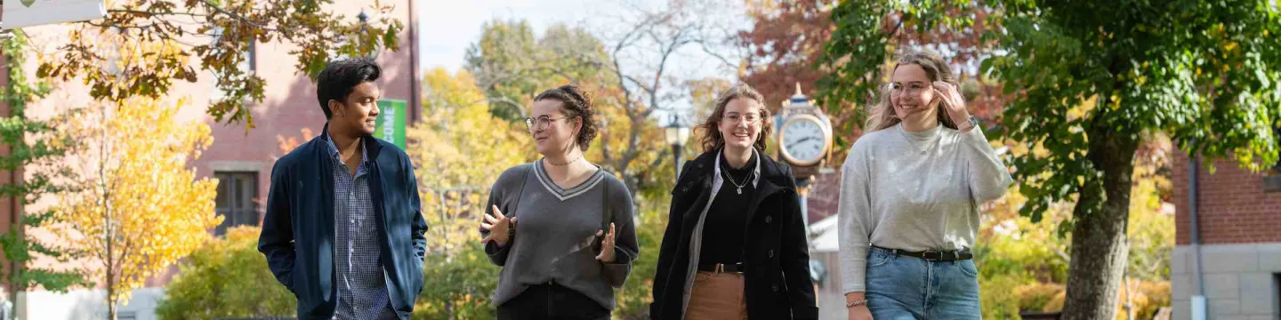 four students in the UPEI quad in fall