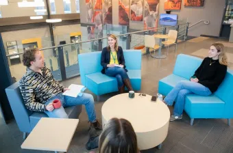 a group of four people sitting around a circular table