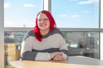 a UPEI student in the Performing Arts Centre and Residence lounge