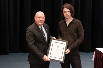 Dr. Max Schaefer receiving an exemplary teaching award from from UPEI president Dr. Greg Keefe.