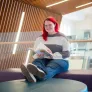 a UPEI student in the Performing Arts Centre and Residence foyer