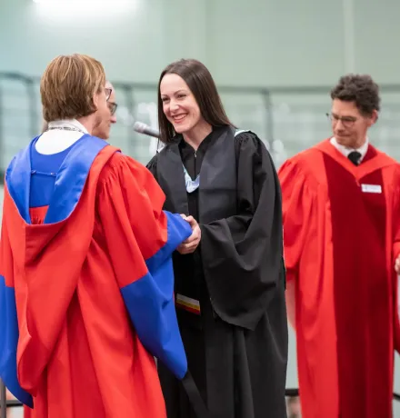 Nicole at UPEI Convocation talking to the dean of education