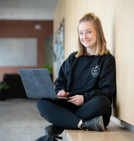 a UPEI education student working on a laptop computer